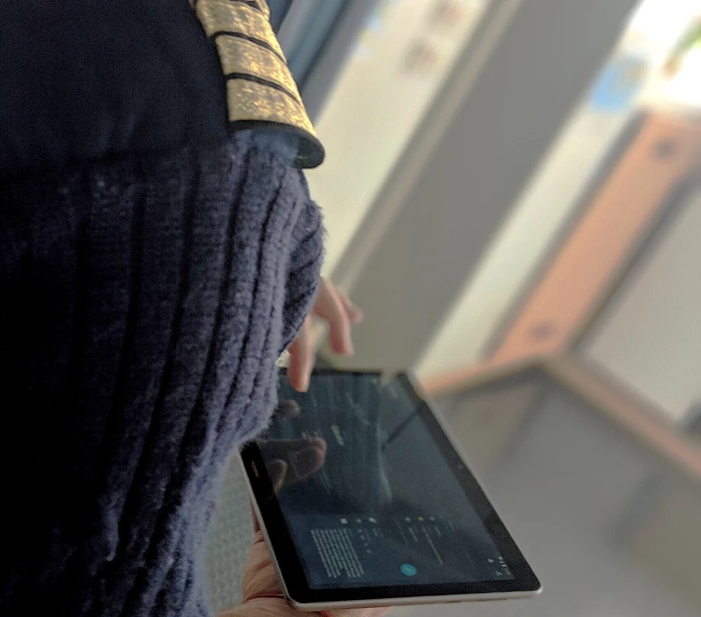 An officer using the tablet on deck